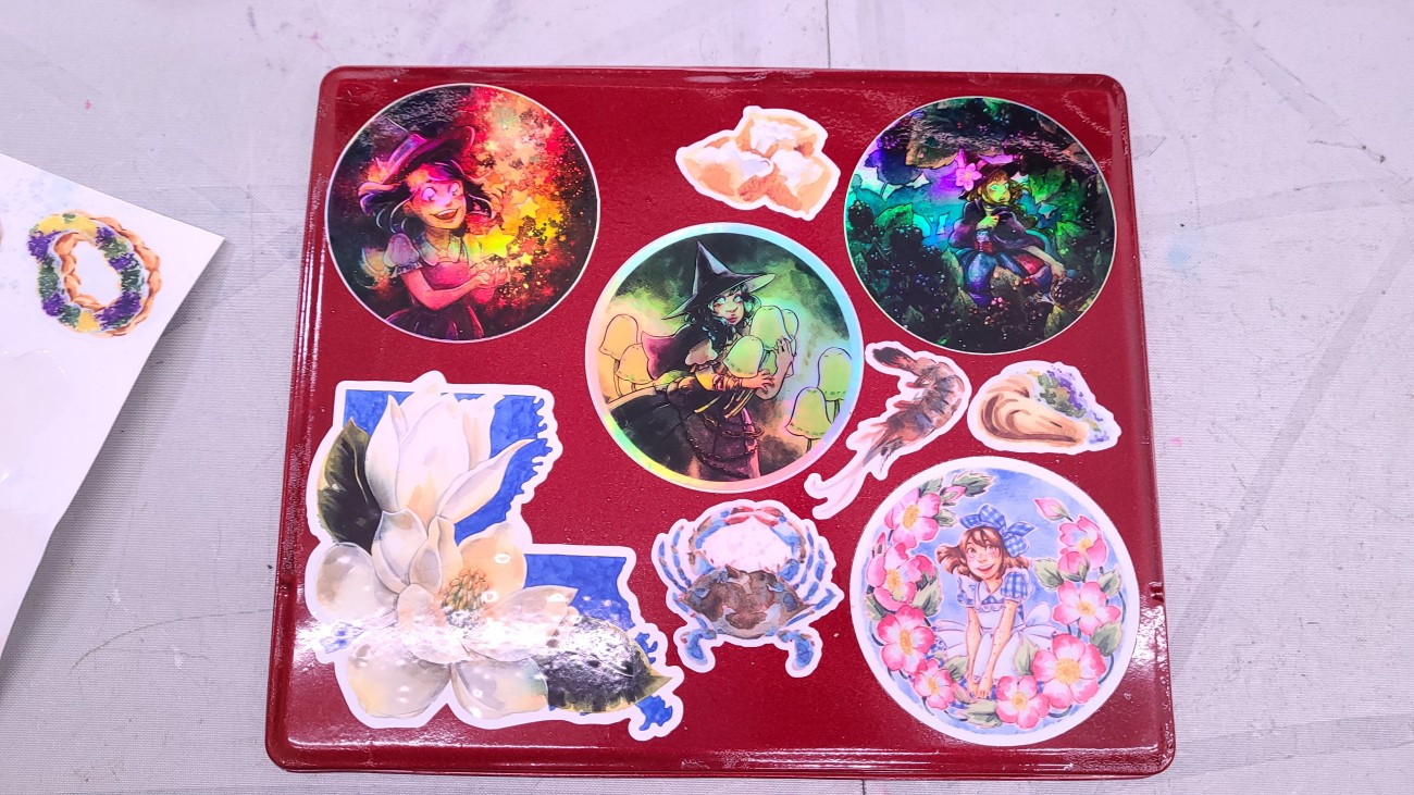 Several of my sticker designs on my custom watercolor palette.  The Ring of Roses sticker is at the bottom right.