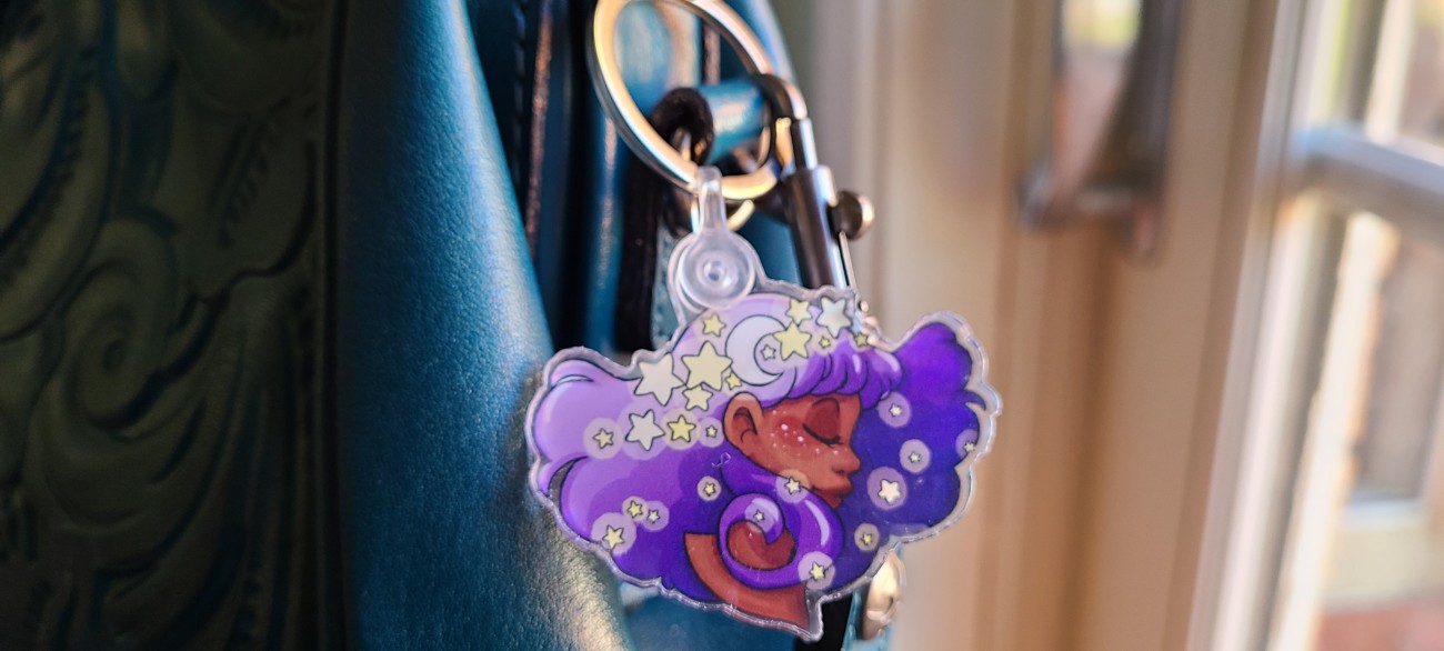 Acrylic charm attached to a purse