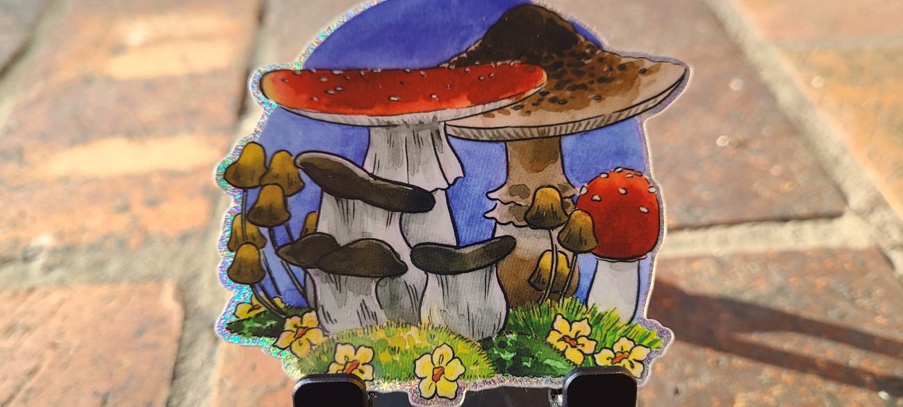 A glittery vinyl sticker of charming little mushrooms.