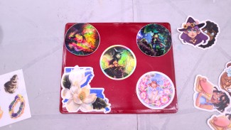 Several of my sticker designs on my custom watercolor palette.  The Holographic Berry Witch is top right.