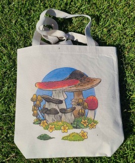 Natural canvas tote bag with my mushroom frog illustration printed across it.