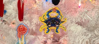 Blue crab acrylic ornament on a white Christmas tree